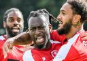 Martell Taylor-Crossdale (centre) celebrates his goal.