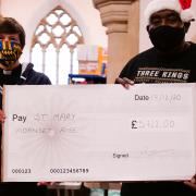 Robbie Lyle and Vicar Tamsin Merchant with the fundraiser money.