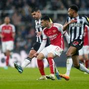 Arsenal's Gabriel Martinelli (centre) passes the ball away from Newcastle United's Bruno Guimaraes (left) and Jacob Murphy. Image: PA