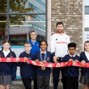 Team GB athlete Morgan Bolding and Aldi Holloway Road store manager Nadya Zhegova cut the ribbon with children from Sacred Heart Catholic Primary School