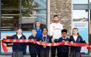 Team GB athlete Morgan Bolding and Aldi Holloway Road store manager Nadya Zhegova cut the ribbon with children from Sacred Heart Catholic Primary School