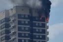 Fifteen fire engines and around 125 firefighters are tackling a flat fire on Manwood Street in North Woolwich