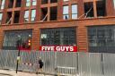 A sign on the front of the upcoming Five Guys burger restaurant in West Hampstead