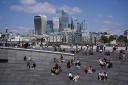 People enjoying the autumnal sunshine by the River Thames in London.