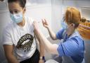 A nurse administers a coronavirus vaccine