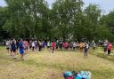 Pre-run briefing; parkrunners distanced and listening intently.