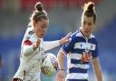 Arsenal's Kim Little (left) and Reading's Angharad James battle for the ball during the FA Women's Super League match at Madejski Stadium