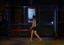 A woman walking alone after dark past a bus stop on Poynders Road in Clapham, south London, close to where Sarah Everard was abducted from the street after being falsely arrested by police officer Wayne Couzens