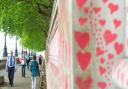 Pedestrians walk past the National Covid Memorial Wall in Westminster, London, following the government announcement of the lifting of almost all coronavirus restrictions from July 19