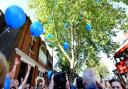 A crowd of Tony's friends, family and customers release blue balloons in Tony's honour.