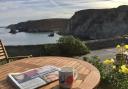 Enjoying the Saturday papers and a cup of coffee outside Pier Cot. Picture: Emma Bartholomew