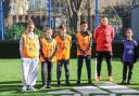 Coach Kai Brennan and young people at the refurbished Harvist Estate pitch