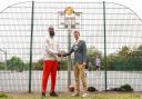 Orlan Jackman and Mayor of Haringey Cllr Lester Buxton pose by his Golden Gateways plaque at Finsbury Park basketball courts