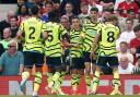 Leandro Trossard celebrates with Arsenal teammates at Old Trafford