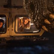 Kayla Watts (DeWanda Wise), Dr. Ellie Sattler (Laura Dern) and a Giganotosaurus in Jurassic World Dominion