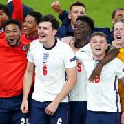 England's Luke Shaw, Tyrone Mings, Reece James, Jude Bellingham, Harry Maguire, Bukayo Saka, Kieran Trippier, Jordan Pickford, Jack Grealish and team-mates celebrate winning the UEFA Euro 2020 semi final match at Wembley Stadium, London. Picture date: