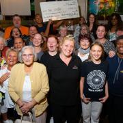 Crib youth member Amy Mulholland and Janette Collins (front centre). Holding the cheque at the back is Ross Harrison, also from The Crib.