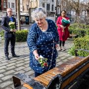 Councillors put down flowers outside the Town Hall. From left: Cllr Richard Watts, Cllr Sue Lukes, and Cllr Kaya Comer-Schwartz