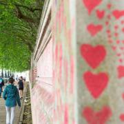 Pedestrians walk past the National Covid Memorial Wall in Westminster, London, following the government announcement of the lifting of almost all coronavirus restrictions from July 19