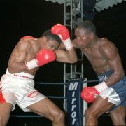 Chris Eubank lands a punch to Michael Watson's head during their WBO title fight at Tottenham's White Hart Lane ground in London.