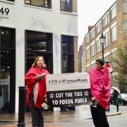 Two Extinction Rebellion activists outside the offices of Hill and Knowlton Strategies