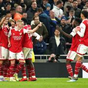 Arsenal players celebrate after Martin Odegaard's goal put them 2-0 up at Tottenham