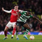 Arsenal's Rob Holding (left) and Sporting Lisbon's Dario Essugo battle for the ball at the Emirates