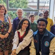 Singer Mae Muller and guitarist Aaron Forbes with (back row, left to right) Principal Emma Gowers, Eleanor, Lucian, Eli and Megan