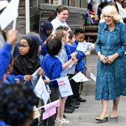 Queen Camilla is greeted by pupils in the courtyard of Moreland Primary School