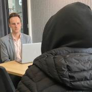 'Sally', with her hood up to disguise her identity, discusses her lawsuit against Islington Council with her lawyer Andrew Lord. She is alleging sexual abuse in the council's Conewood Street children's home, later renamed Park Place