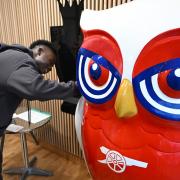 Arsenal's Bukayo Saka signs an owl sculpture ready for auction in aid of North London hospice