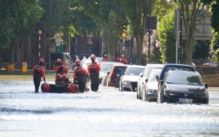 London Fire Brigade ferry local residents along Hornsey Road after water pipe burst