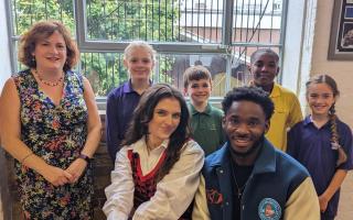 Singer Mae Muller and guitarist Aaron Forbes with (back row, left to right) Principal Emma Gowers, Eleanor, Lucian, Eli and Megan